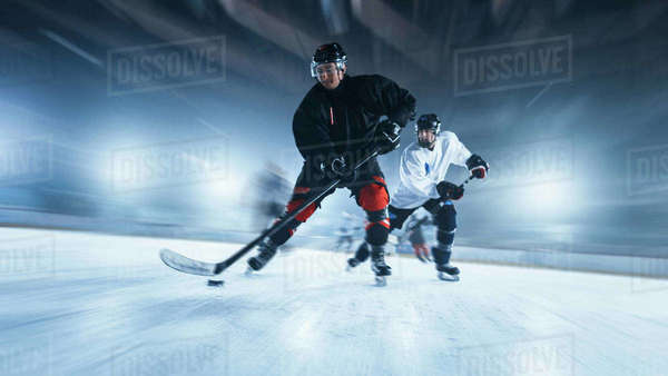 Ice Hockey Rink Arena: Professional Forward Player Masterfully Dribbles ...