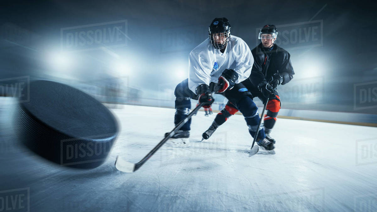 Blurred Motion Shot with 3D Flying Puck. Two Professional Ice Hockey