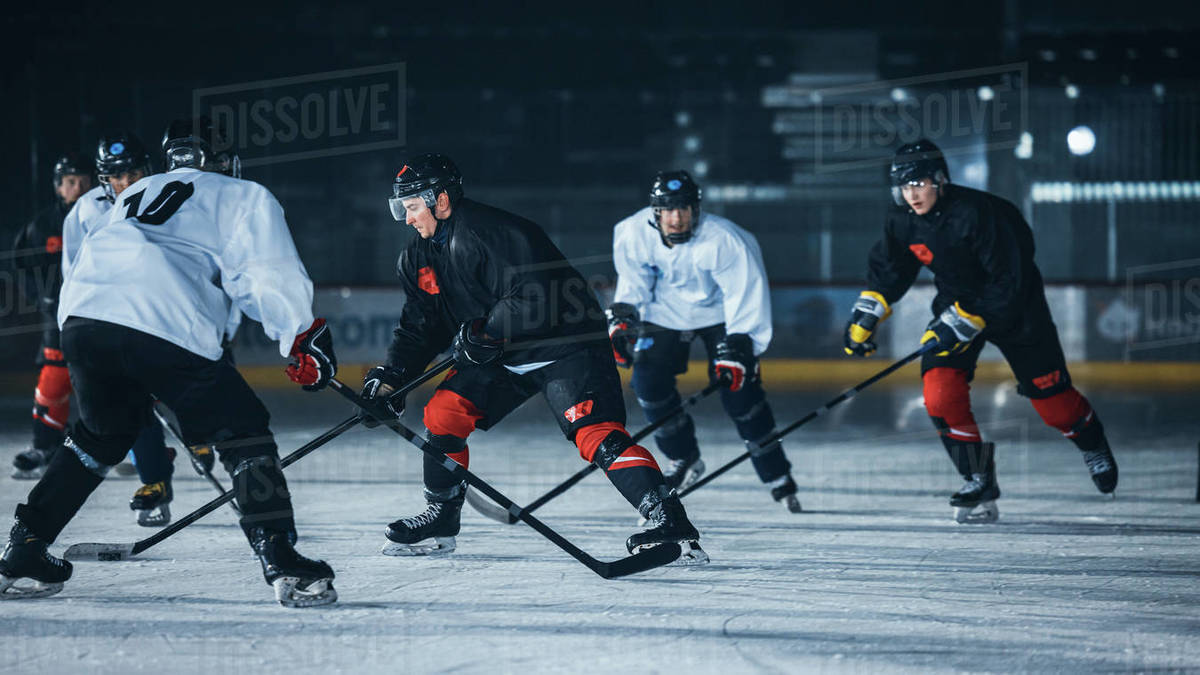 Dark Ice Hockey Rink Arena Young Players Training, Learning Stick and Puck Handling. Athletes