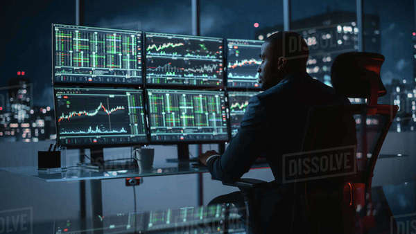 Hedge Fund Trader Working on a Computer with Multi-Monitor Workstation ...