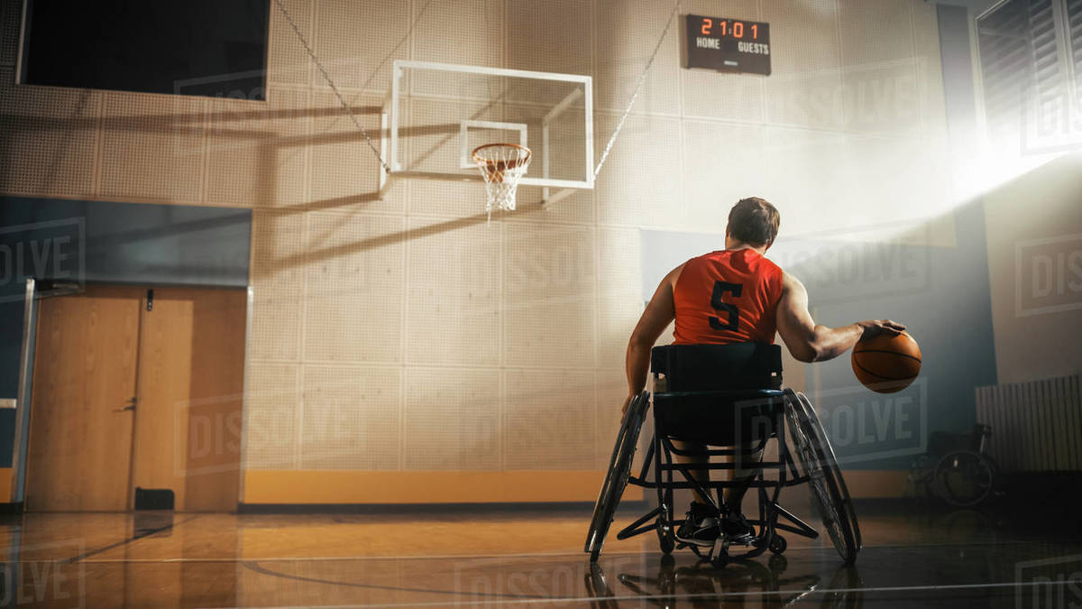 Wheelchair Basketball Player Wearing Red Shirt Dribbling Ball Like a