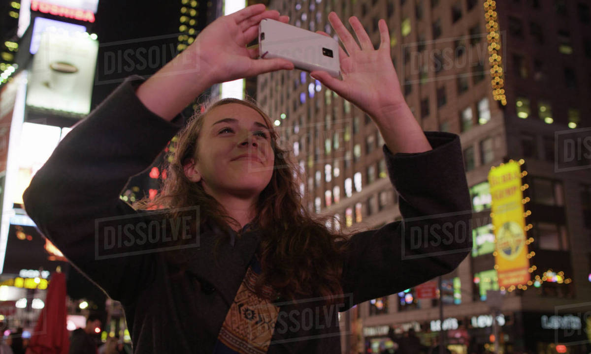 Woman taking photographs in Times Square, New York City Royalty-free stock photo