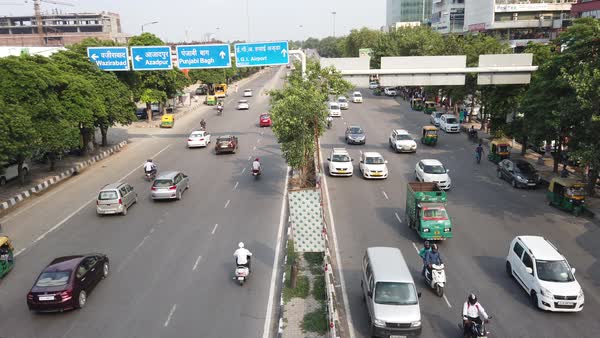 Top view looking down at busy road intersection with vehicular traffic ...