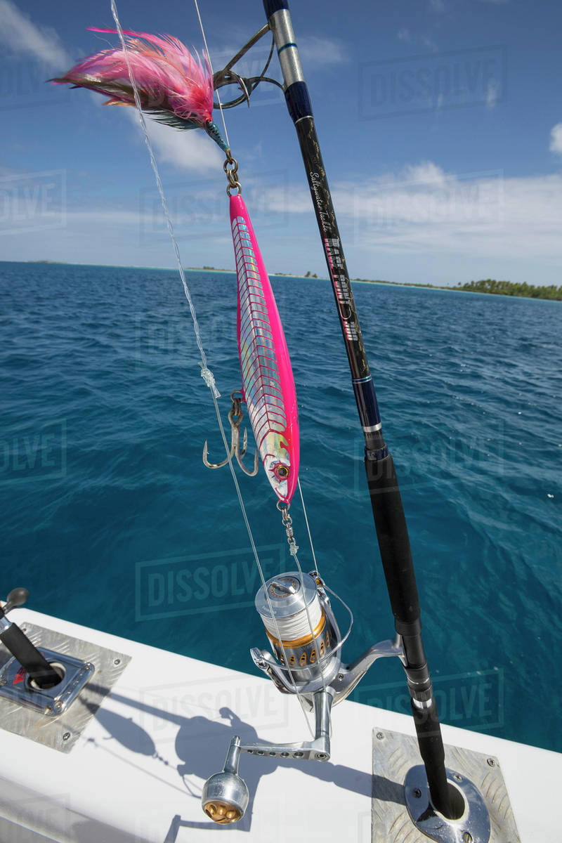 Fishing rod with lure on a boat; Tahiti Stock Photo Dissolve