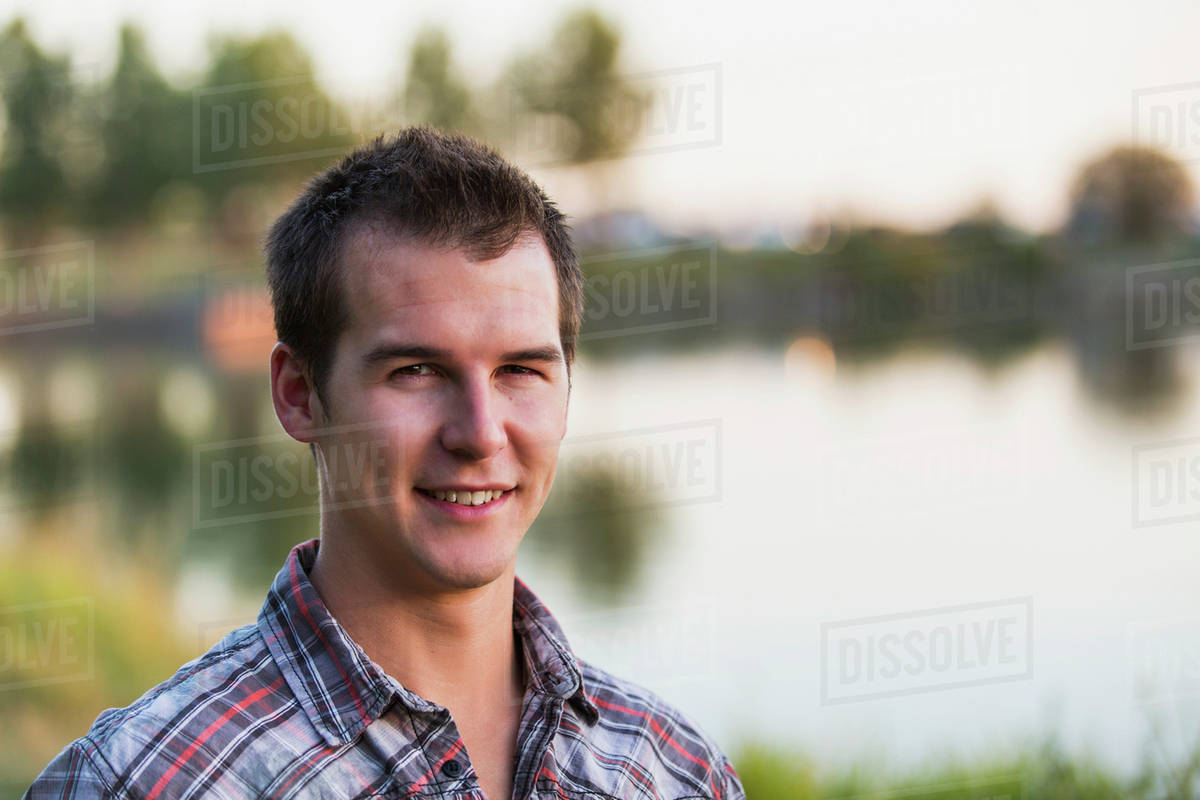 portrait-of-a-young-man-beside-a-lake-in-autumn-st-albert-alberta