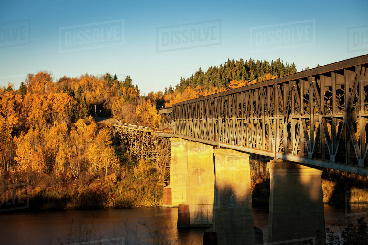 A truss bridge over a river in autumn; Nipawin, Saskatchewan, Canada