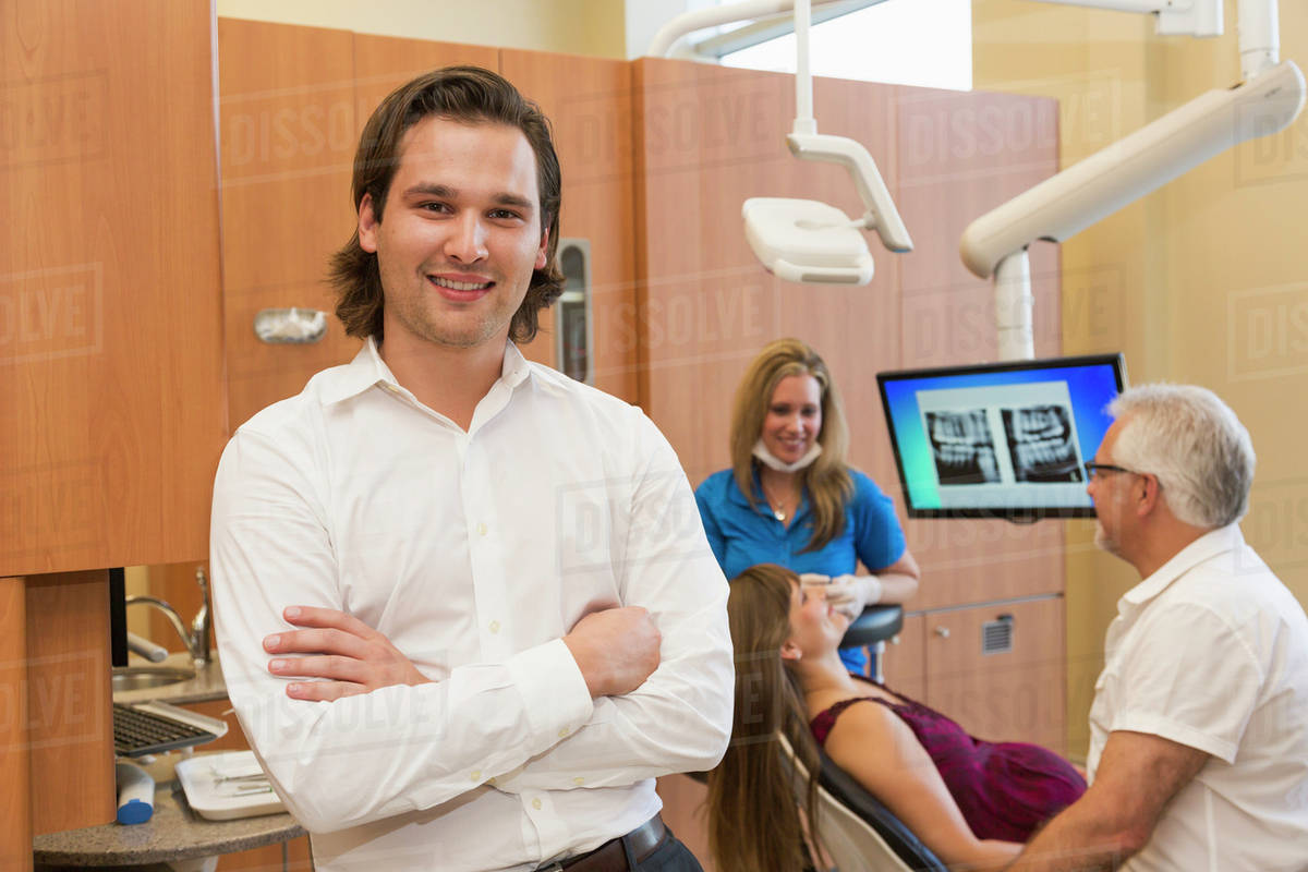 Associate dentist posing during patient consultation; Edmonton, Alberta
