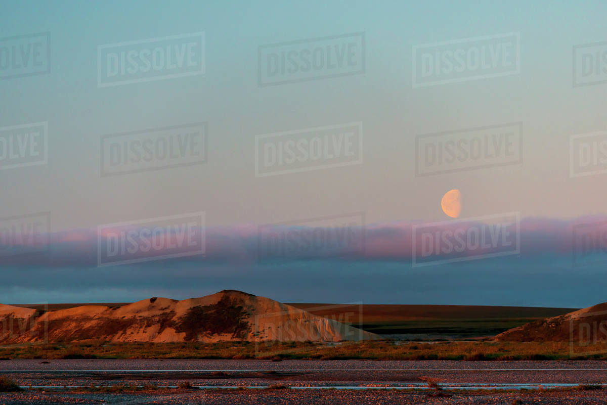 Half moon over Bluff bank; Dead Horse, Alaska, United States of America