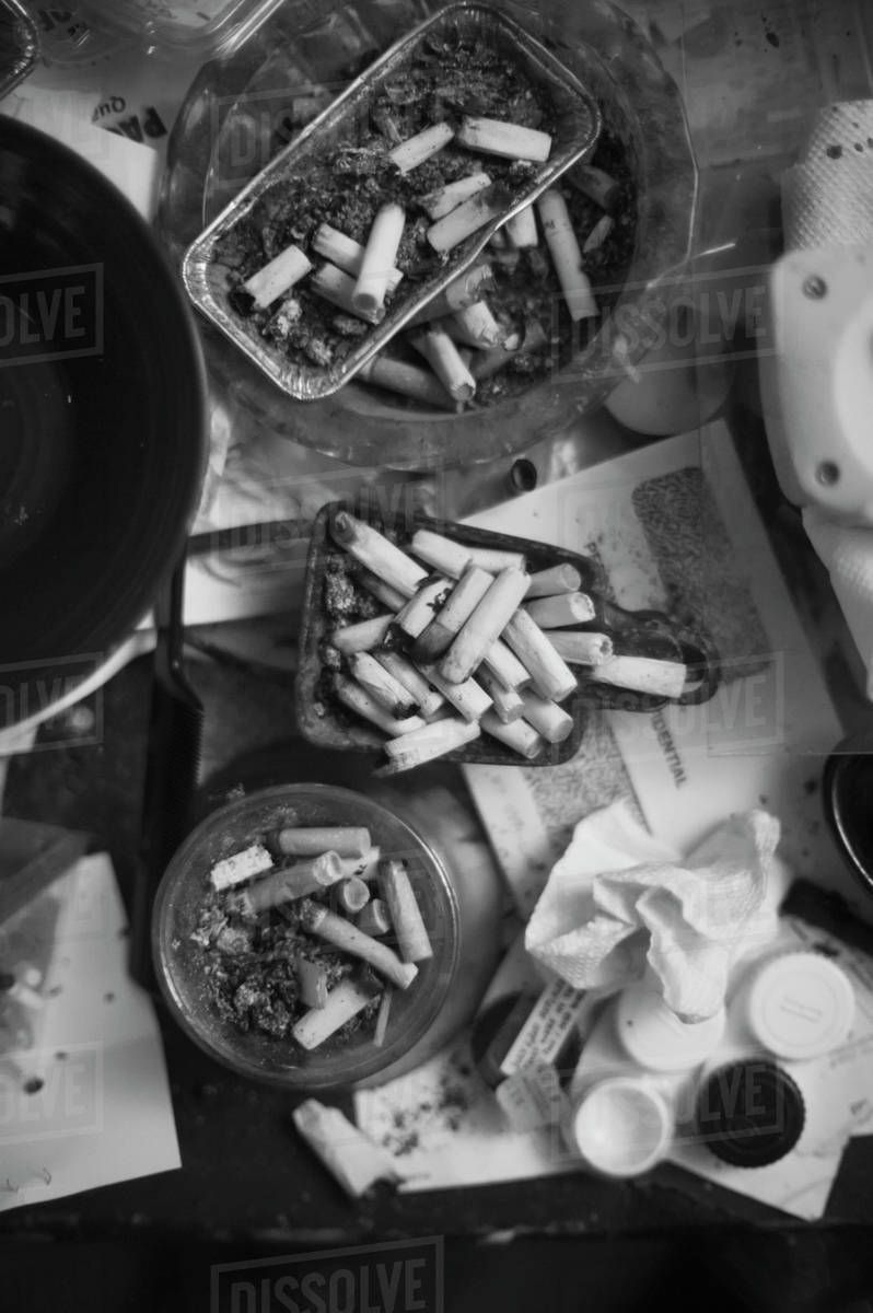 Black and white close up of cigarette butts in ashtrays; Baltimore,  Maryland, United States of America - Royalty-free Stock Photo