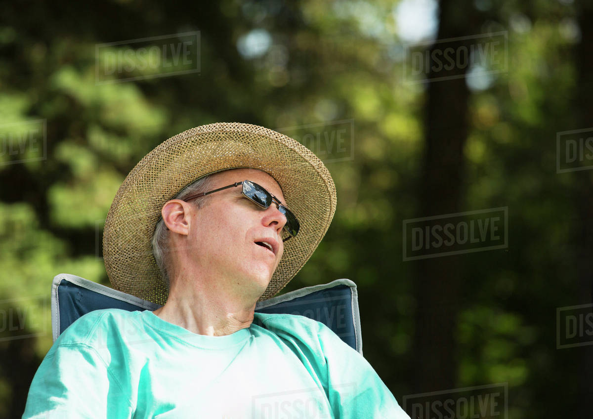 Man sleeping in a park; Edmonton, Alberta, Canada Stock Photo Dissolve