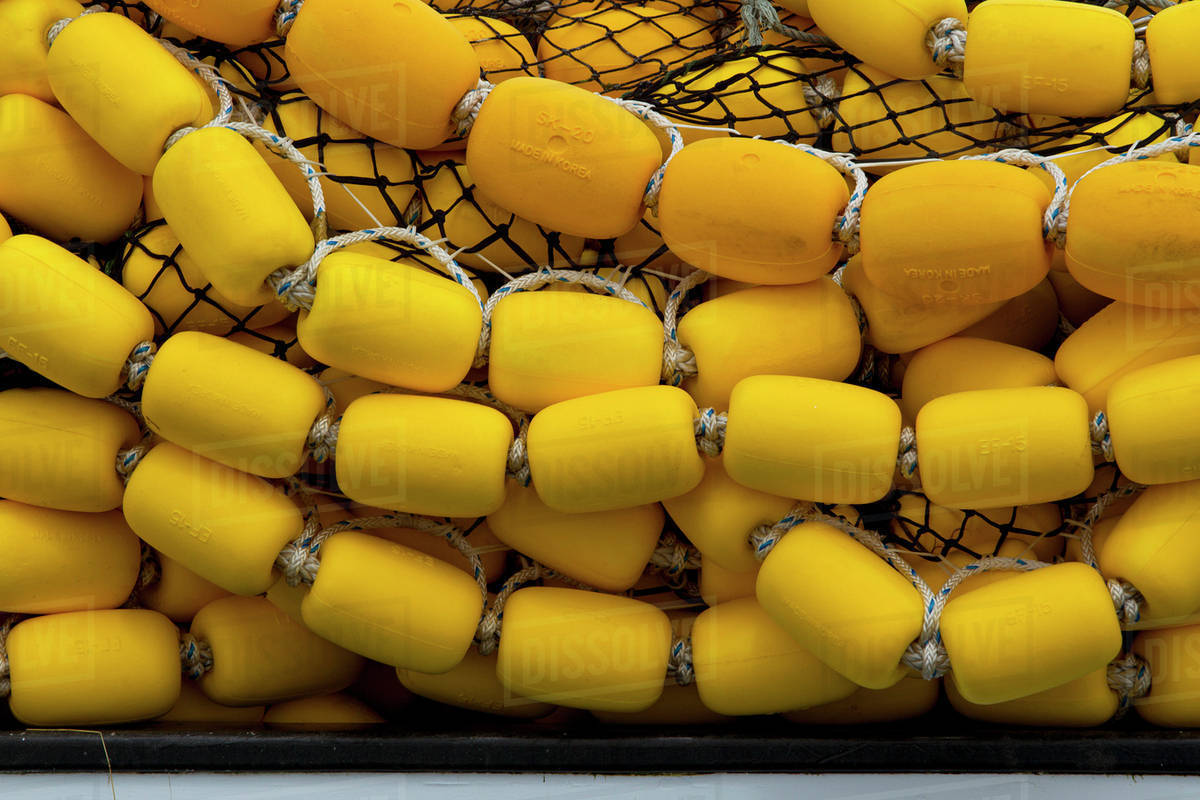 Bright Yellow Corks And Commercial Fishing Seine Net Stacked On Deck