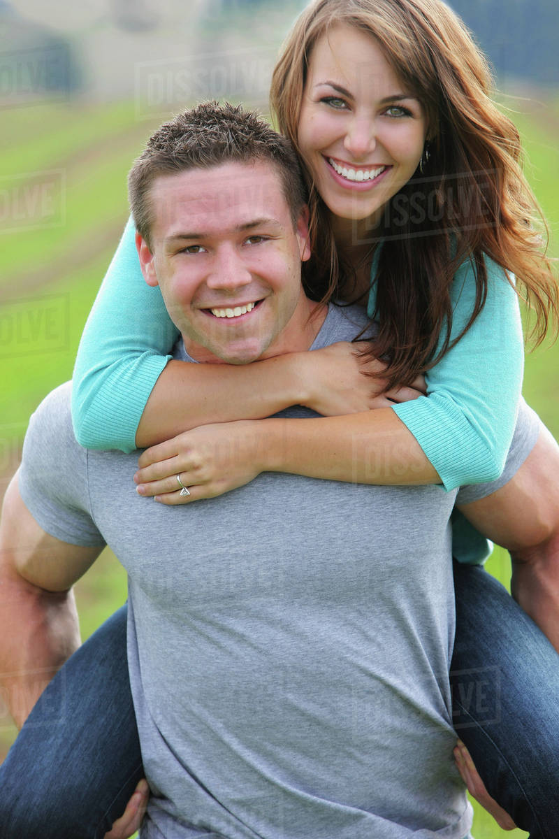 Guy Giving Girl A Piggyback Ride; Troutdale, Oregon, United States of