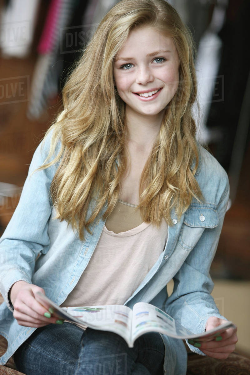 Teenage Girl With Long Blond Hair And Blue Eyes Reading A Magazine 5449