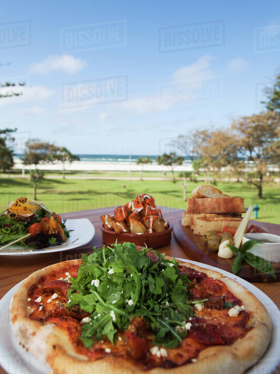 Pizza And Spanish Tapas; Kirra Gold Coast, Queensland, Australia Stock Photo Dissolve