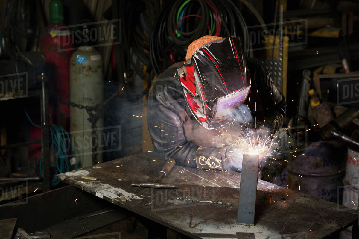 Female welder welding in a shop;Edmonton alberta canada Stock Photo Dissolve