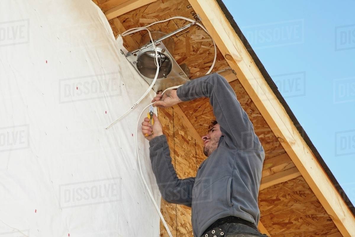 Electrician Installing Light Fixtures On House Stock Photo Dissolve