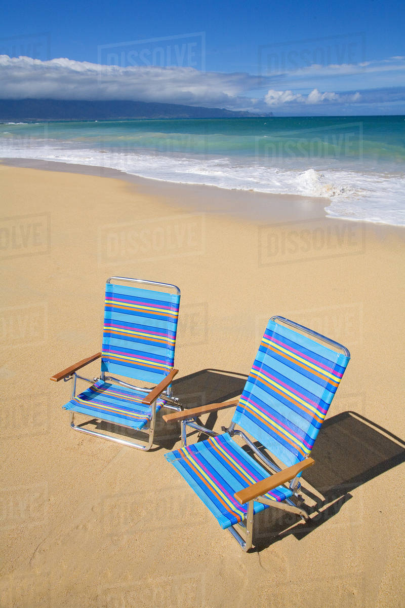 Brightly Colored Beach Chairs On The Sand Near Ocean Stock Brightly Colored Beach Chairs On The Sand Near Ocean