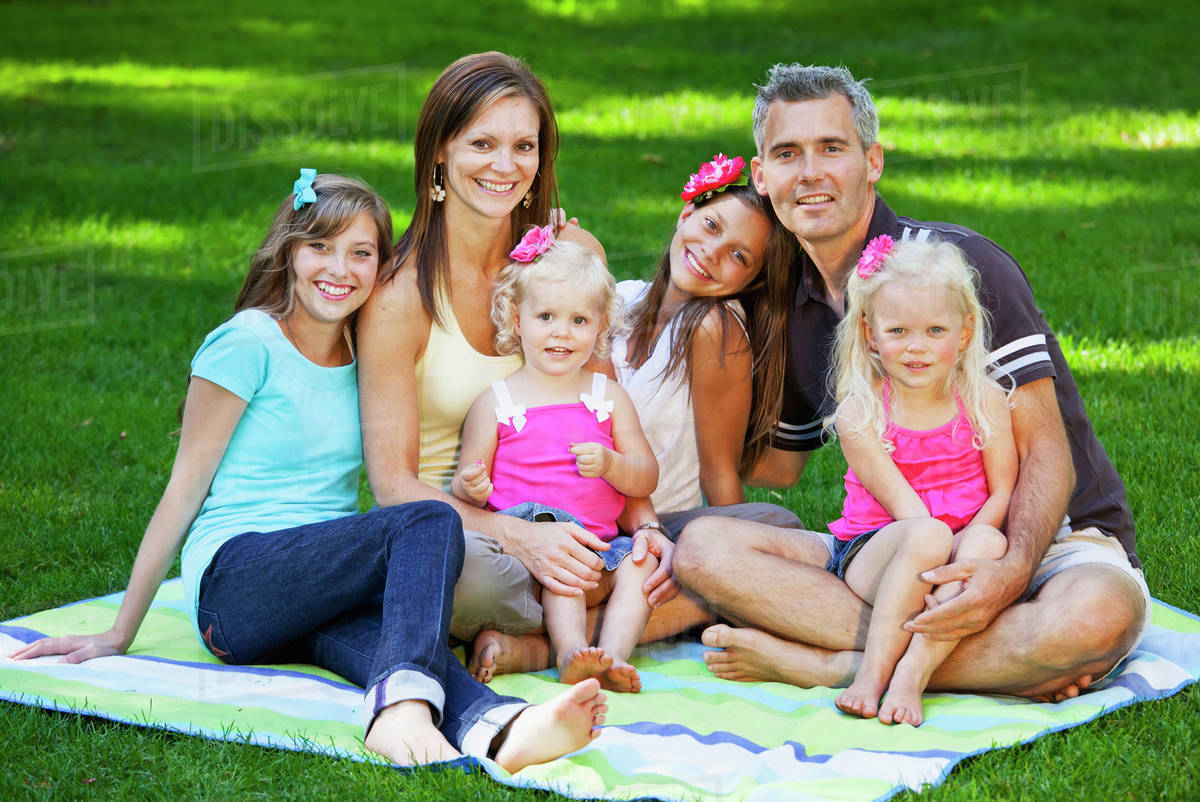 Portrait Of A Family In The Park On A Blanket; Edmonton, Alberta