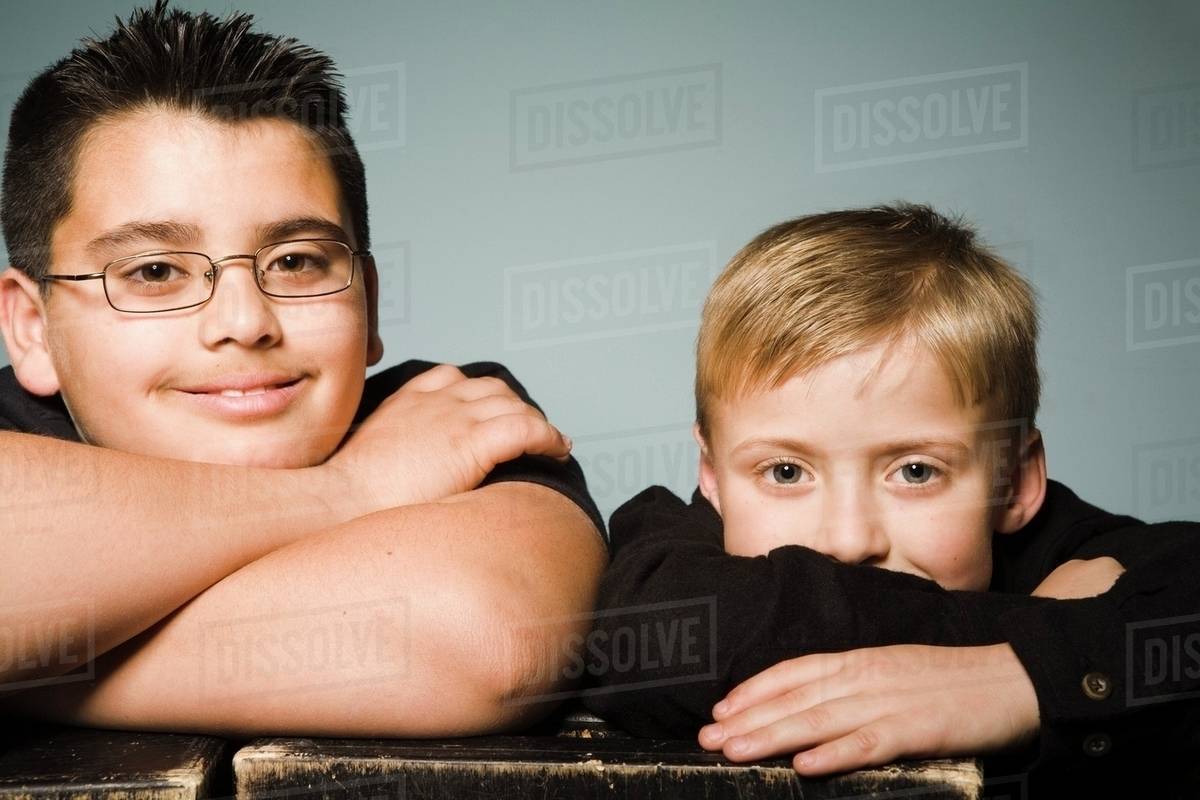 Two Boys With Their Arms Crossed Stock Photo Dissolve