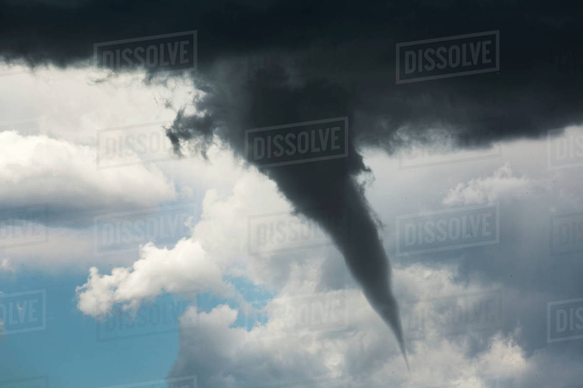 Dramatic funnel cloud created in dark storm clouds; Calgary, Alberta