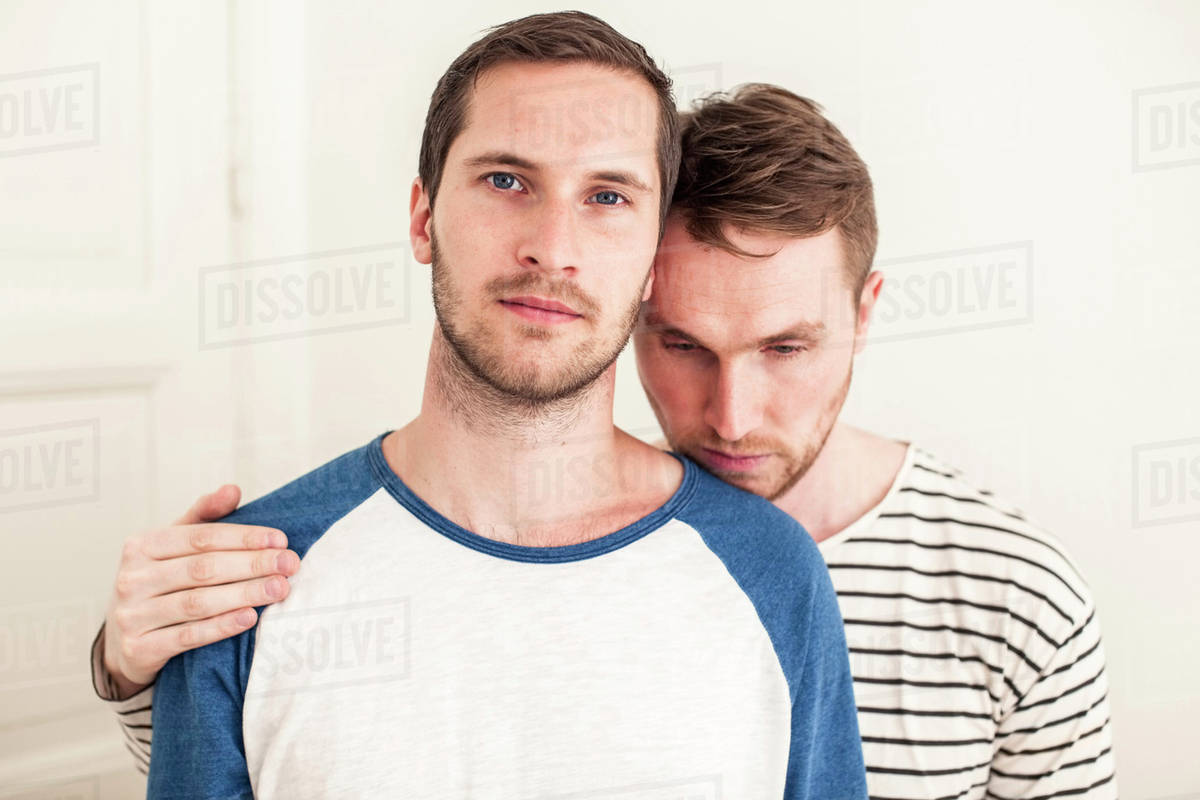 Portrait of young gay man with loving partner at home Royalty-free stock photo