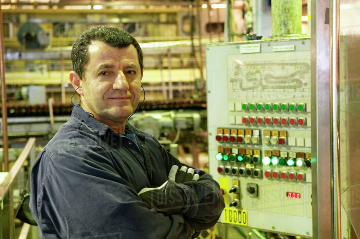 Man standing by control panel - Royalty-free Stock Photo | Dissolve