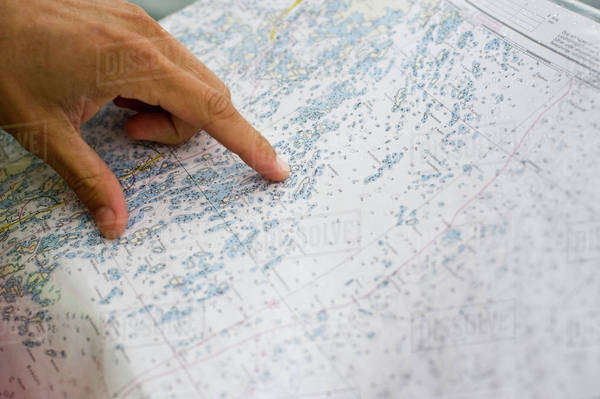 Hand pointing at map - Stock Photo - Dissolve