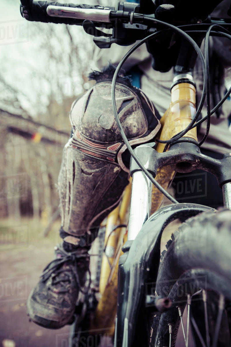 Low section of woman wearing kneepad while riding mountain bike Royalty-free stock photo