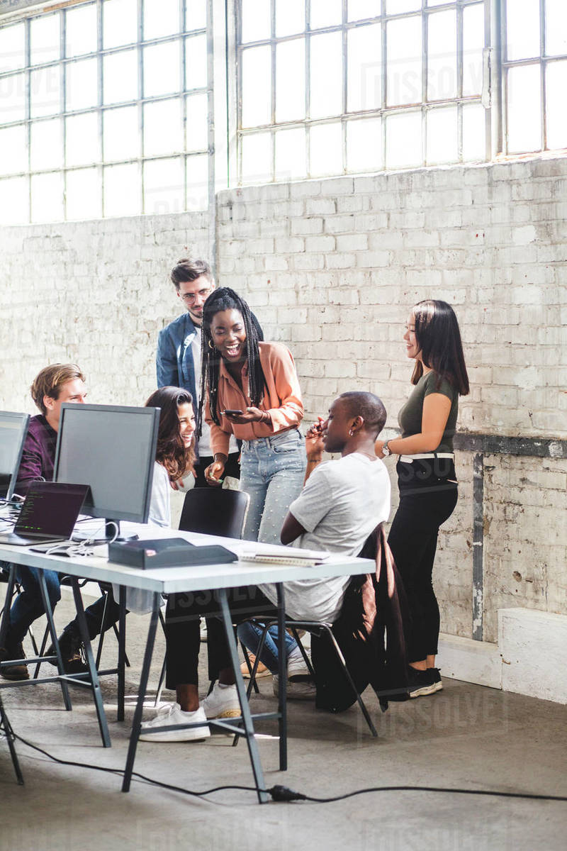 Team of happy computer hackers working together in creative office Royalty-free stock photo