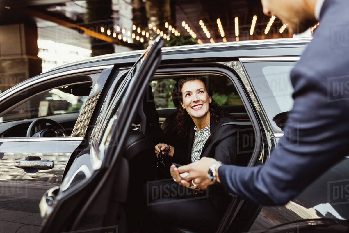 Smiling female entrepreneur looking at male coworker while