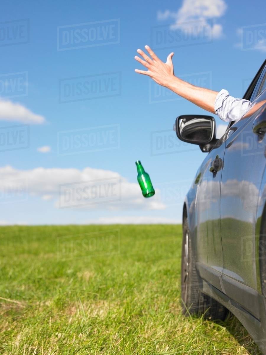 Man throwing bottle away Stock Photo Dissolve