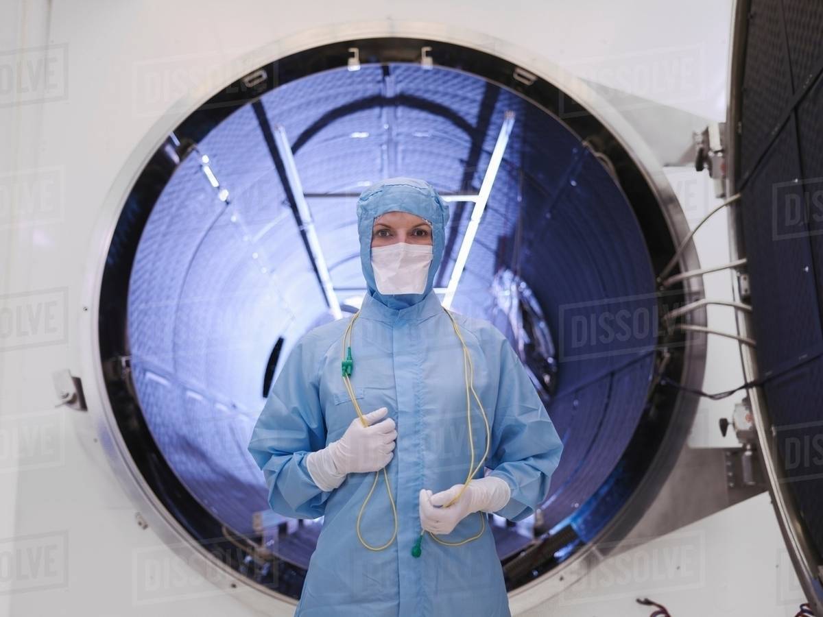 Worker with satellite testing chamber Stock Photo Dissolve