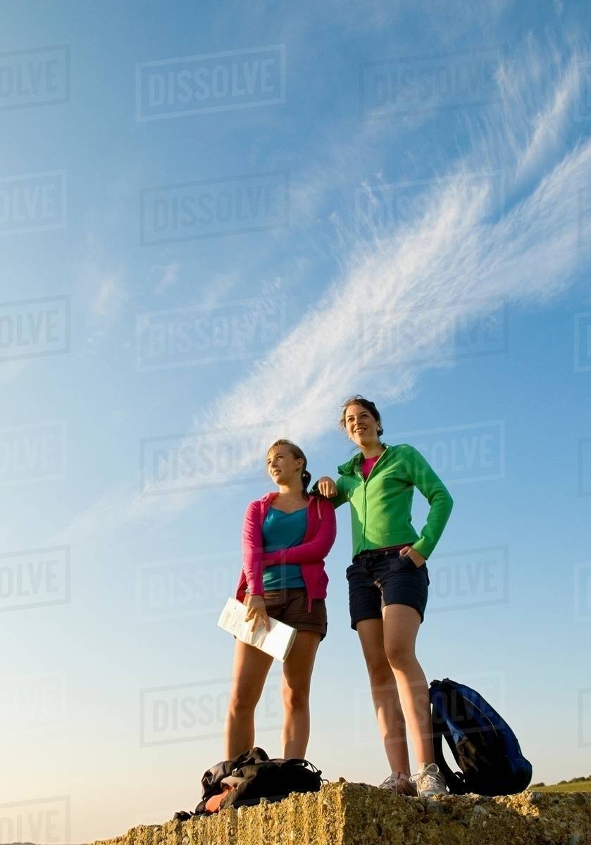 Female hikers relax after long trex Stock Photo Dissolve