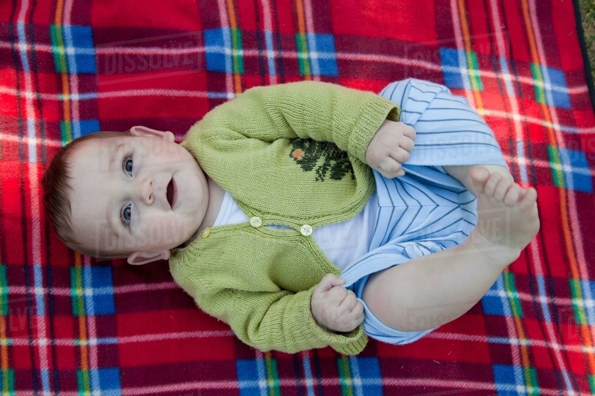 Baby boy rolling on blanket Stock Photo Dissolve