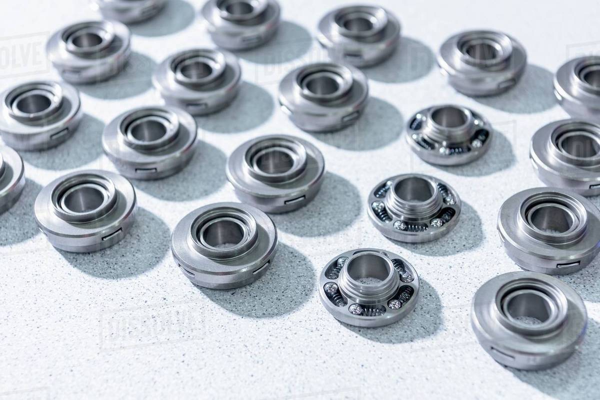 Valve rotators on assembly line in automotive parts factory Stock