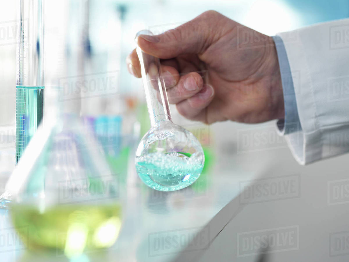 Scientist preparing a chemical formula in a conical flask during an