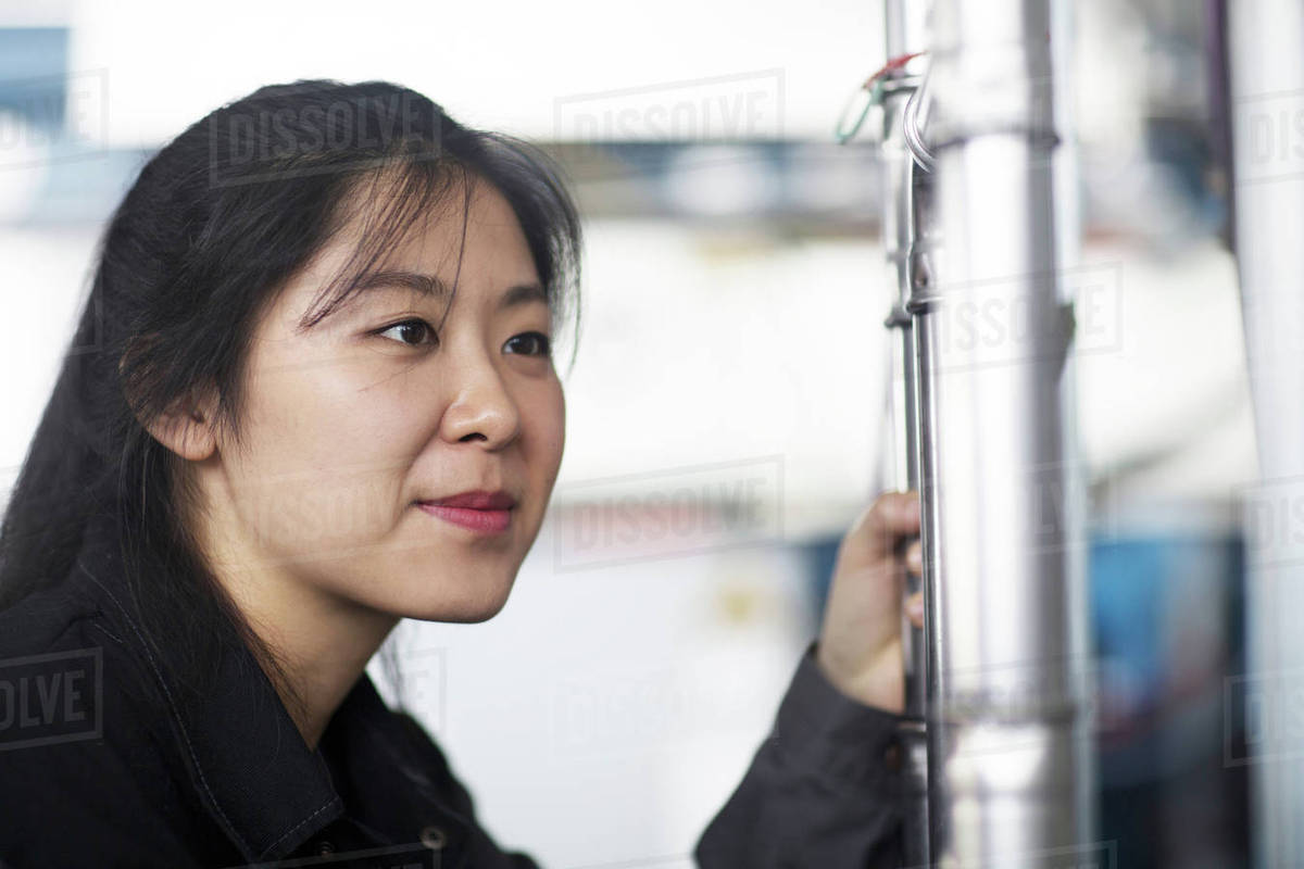 technician-operating-machine-in-factory-stock-photo-dissolve