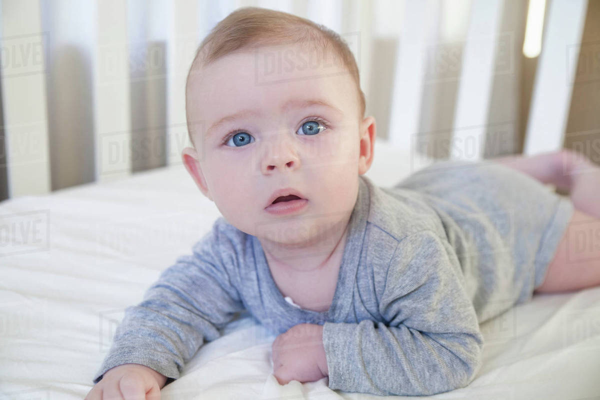 Baby boy waking up in his crib Stock Photo Dissolve