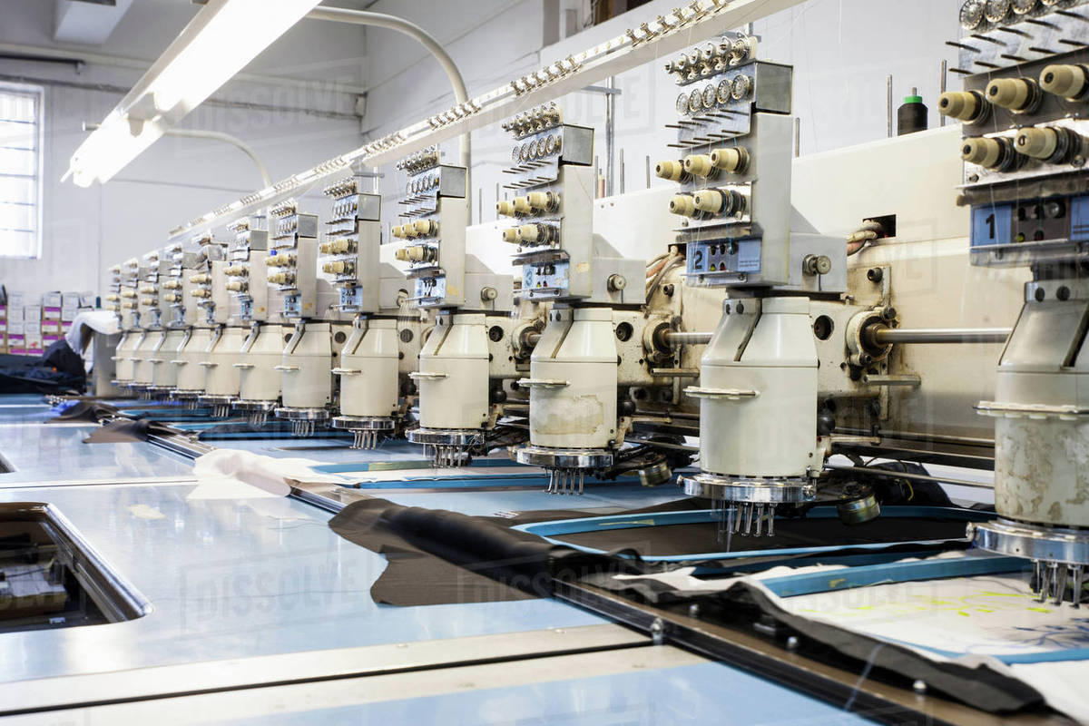Rows of programmed embroidery machines speed stitching in clothing