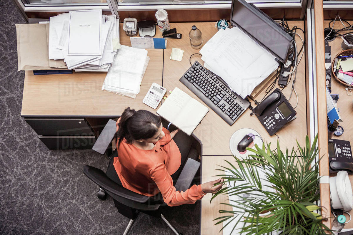 Overhead View Of Businesswoman Busy At Office Desk Stock Photo Businesswoman Busy At Office Desk