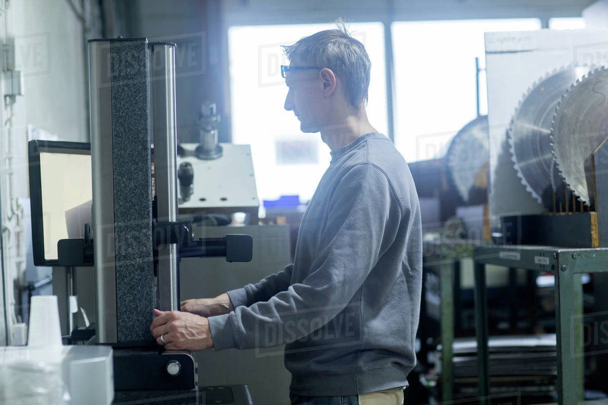 Man working in grinding Stock Photo Dissolve