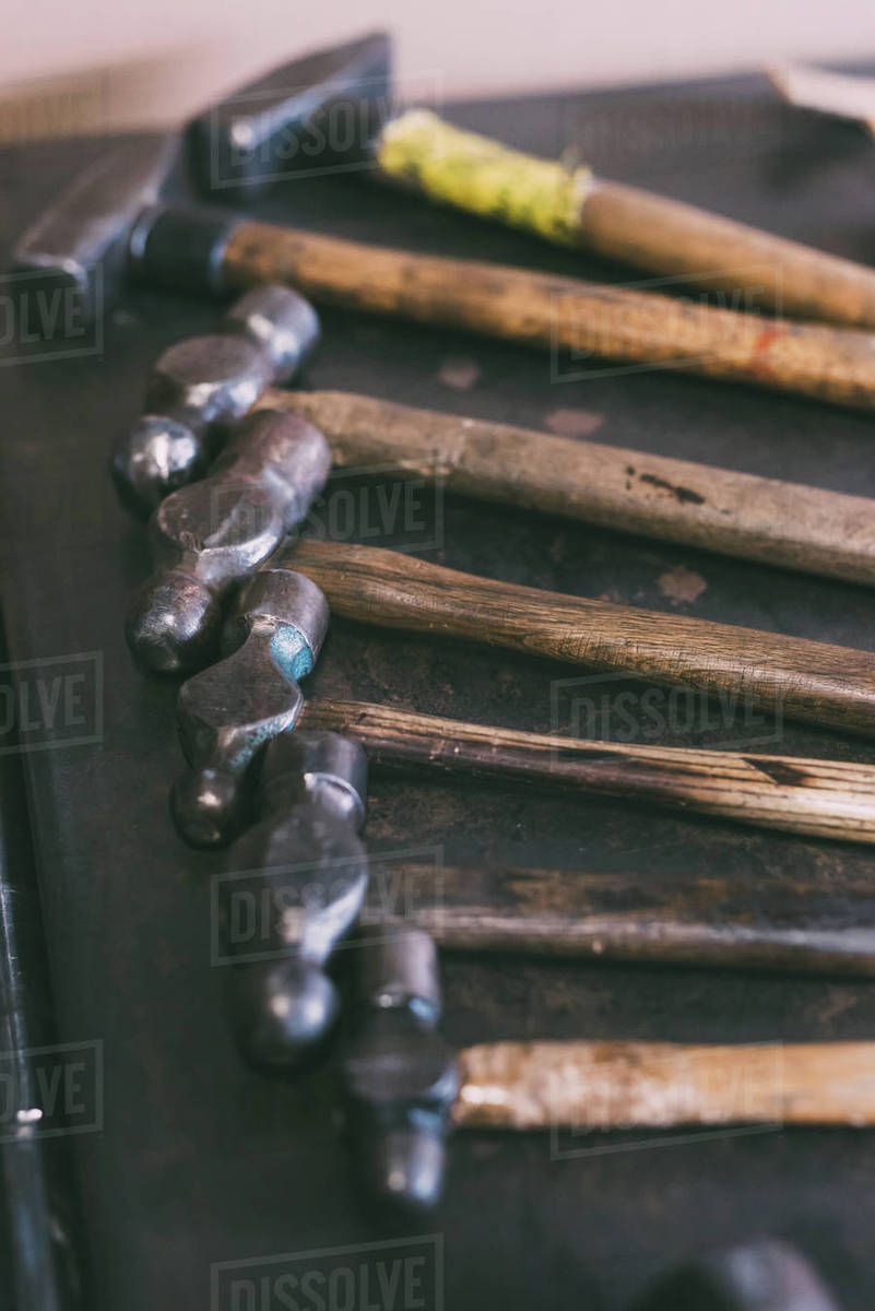 Row of hammers on workbench Stock Photo Dissolve