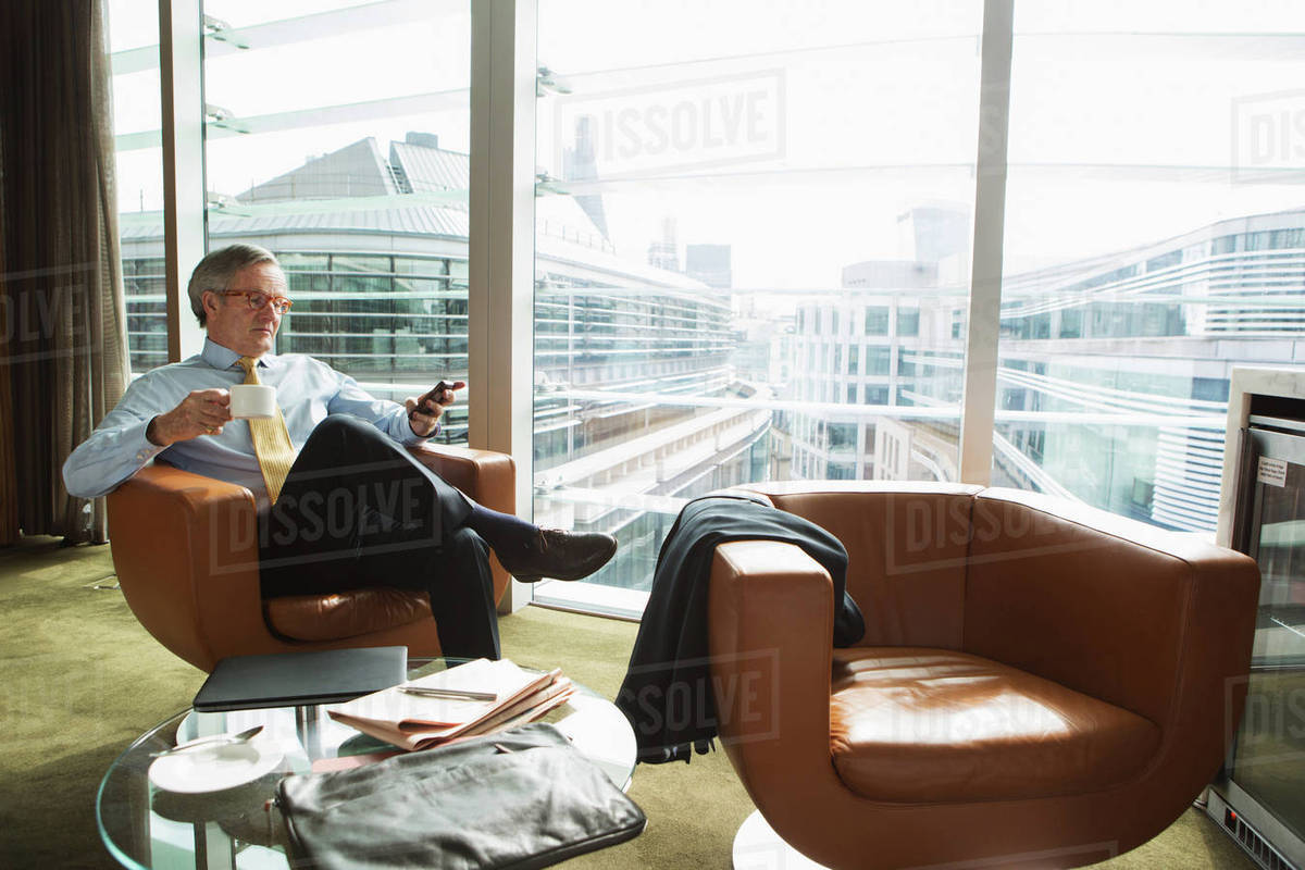 Businessman in coffee area in office, London, UK Royalty-free stock photo