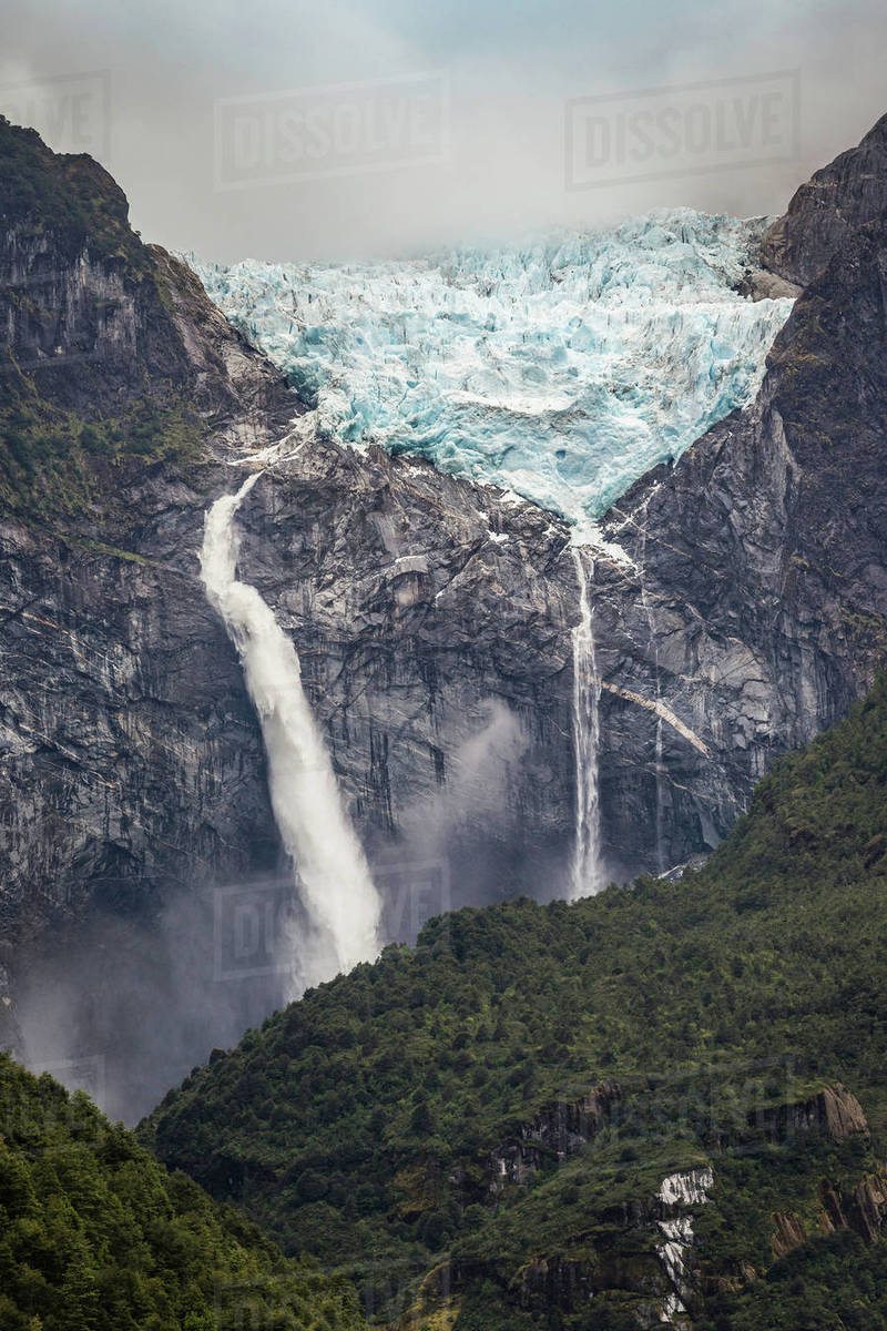 Waterfall Flowing From Glazier At Edge Of Mountain Rock Face Waterfall Flowing From Glazier At Edge Of Mountain Rock Face Queulat National Park Chile