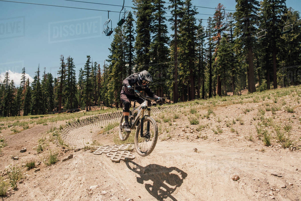 Man cycling on dirt track, jumping bike trick, Mammoth Lakes, California, USA, North America Royalty-free stock photo