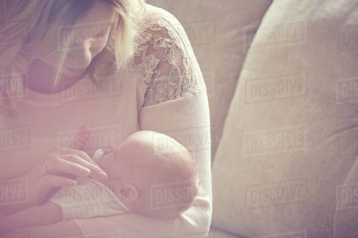 Newborn baby boy, sleeping in mother's arms, closeup Stock Photo