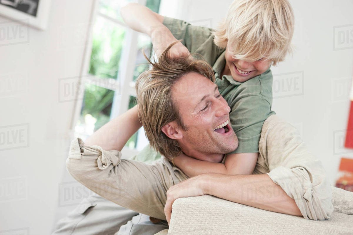 Father and son play fighting Stock Photo Dissolve