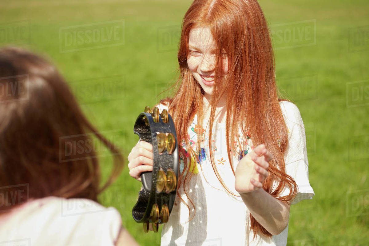 Girl playing tambourine Stock Photo Dissolve