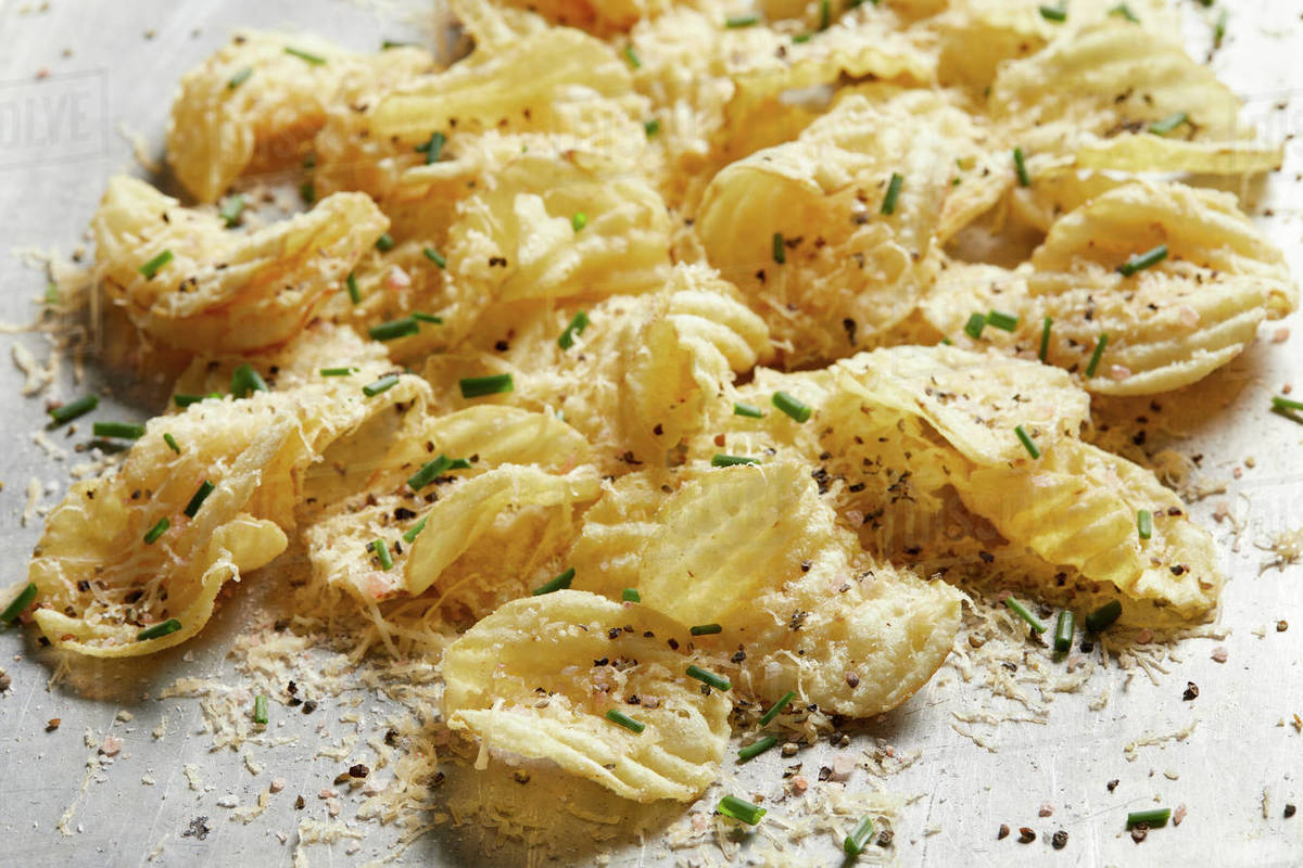Potato chips with green onion and smoke gouda Stock Photo Dissolve