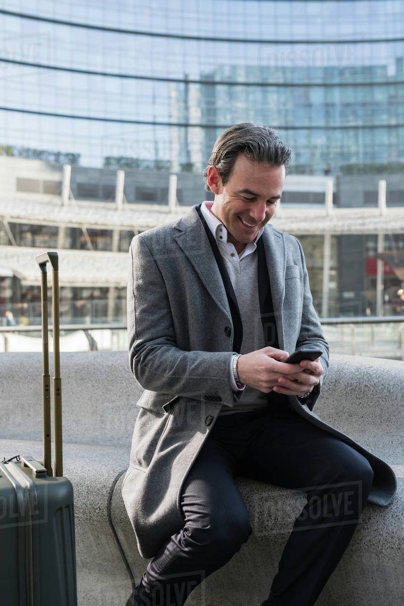 Businessman using smartphone in city centre, Milan, Lombardia, Italy Royalty-free stock photo